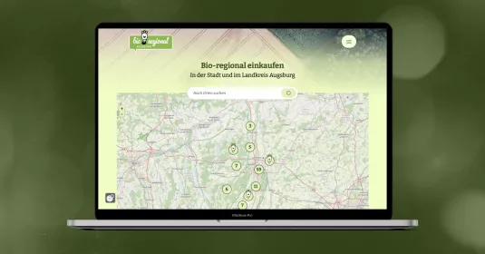 Mockup der Bio-regional Webseite auf einem Macbook-Display